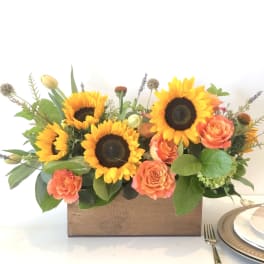 Sunflower and coral rose arrangement in a wooden box