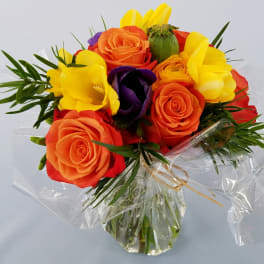 Bouquet of orange, yellow, red, and purple flowers wrapped in clear plastic