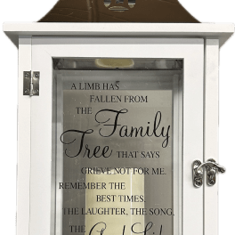 White memorial lantern with a candle and sympathy quote inside
