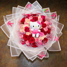 Bouquet of red and pink roses with a Hello Kitty plush in white wrapping