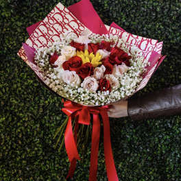 Bouquet of red and blush roses with yellow flowers and baby's breath