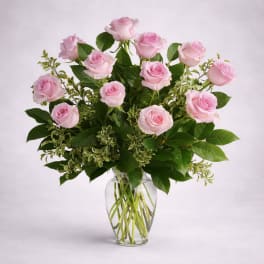Pink roses arranged in a clear glass vase