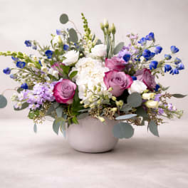 Mixed bouquet of pink and white flowers in a white vase