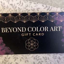 A Beyond Color Art gift card on patterned fabric