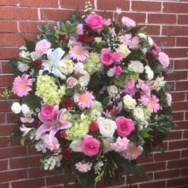 Large pink and white floral standing spray with lilies and roses