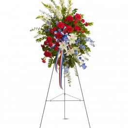 Standing floral spray with red, white, and blue flowers on an easel
