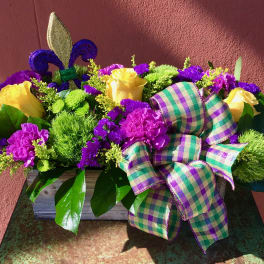 Yellow roses and purple flowers in a wooden box with a plaid ribbon