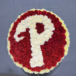 Round red and white floral wreath on a stand