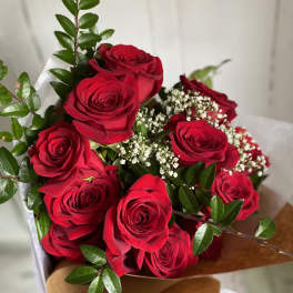 Bouquet of red roses with baby's breath and greenery