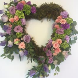 Heart-shaped floral wreath with pink, purple, and green blooms