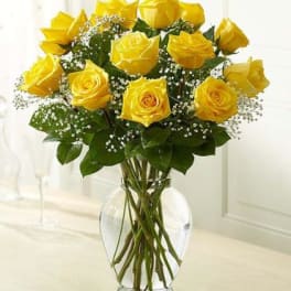 Yellow roses arranged in a clear glass vase
