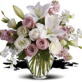 Bouquet of pink and white flowers in a clear glass vase