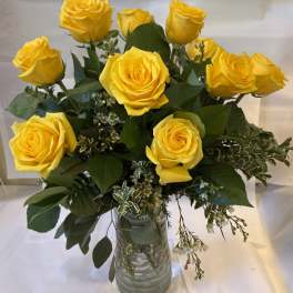Bouquet of yellow roses in a clear glass vase