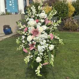Standing floral spray with white roses, pink lilies, and white blooms