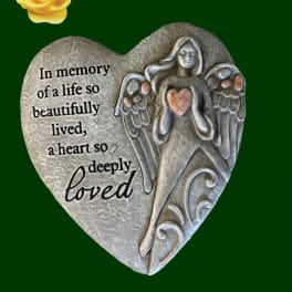 Heart-shaped memorial plaque with an angel and a yellow rose