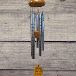 Hanging silver wind chime with a wooden top and yellow accent pieces