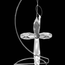 Crystal cross ornament hanging on a silver metal stand