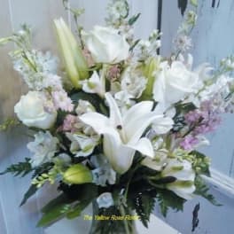 White lilies and roses in a glass vase