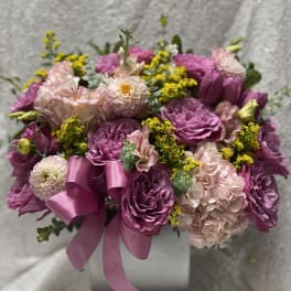 Pink and purple bouquet with a satin ribbon in a box