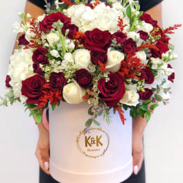 Large bouquet of red and white roses in a white hat box