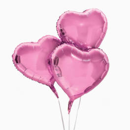 Three pink heart-shaped balloons on sticks