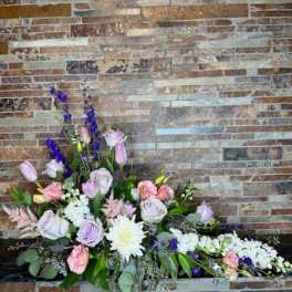 Large floral arrangement with pink, white, and purple blooms