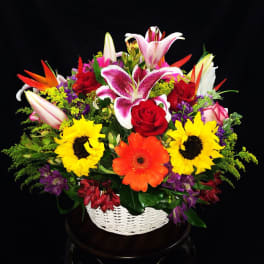 Colorful mixed flower basket with lilies, roses, sunflowers, and gerbera daisies