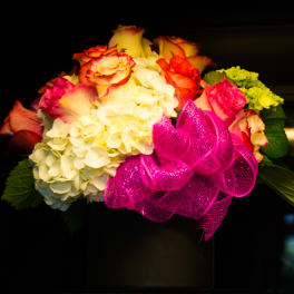 Bouquet of roses and hydrangeas with a bright pink ribbon