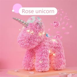 Pink rose-covered unicorn figure with a silver horn on a pink background