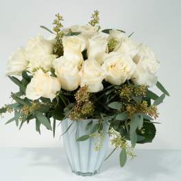 White rose bouquet in a clear glass vase