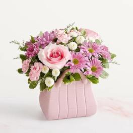 Pink rose and daisy bouquet in a pink vase