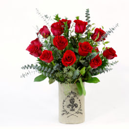 Red roses arranged in a burlap-wrapped vase