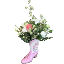 Bouquet of pink and white flowers arranged in a painted boot vase