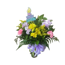 Birthday bouquet with yellow and pink flowers in a vase
