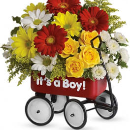 Bouquet of red, yellow, and white flowers in a red wagon