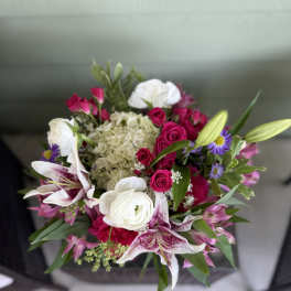 Bouquet of pink roses, white lilies, and purple daisies
