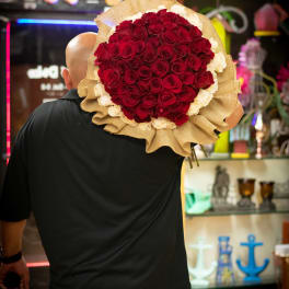 Large bouquet of red and white roses wrapped in burlap
