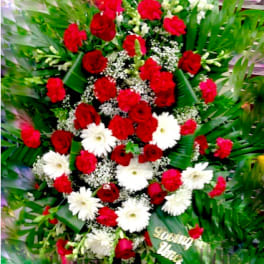 Red and white floral standing spray with greenery