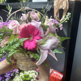 Pink and white mixed bouquet in a woven basket