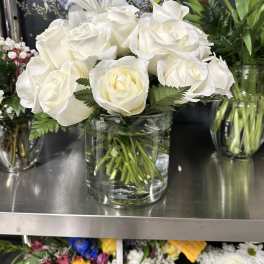White roses arranged in a clear glass vase