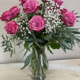 Pink roses and baby's breath in a clear glass vase