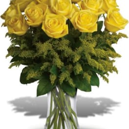 Yellow roses arranged in a clear glass vase