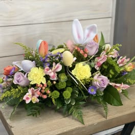 Easter floral arrangement with pastel flowers and decorative eggs