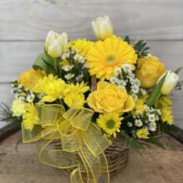 Yellow flower basket with roses, daisies, and tulips