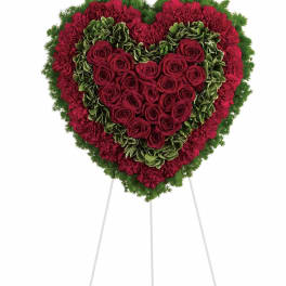 Heart-shaped standing floral tribute with red roses and carnations