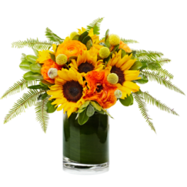 Sunflower and orange flower arrangement in a glass vase
