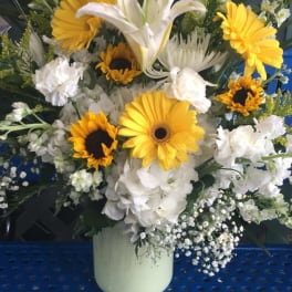 White lilies and yellow gerbera daisies in a vase