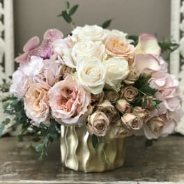 Blush and white rose bouquet in a gold vase