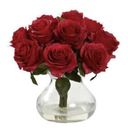 Red roses arranged in a clear glass vase