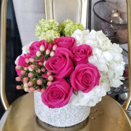 Pink roses and white hydrangeas in a white decorative box